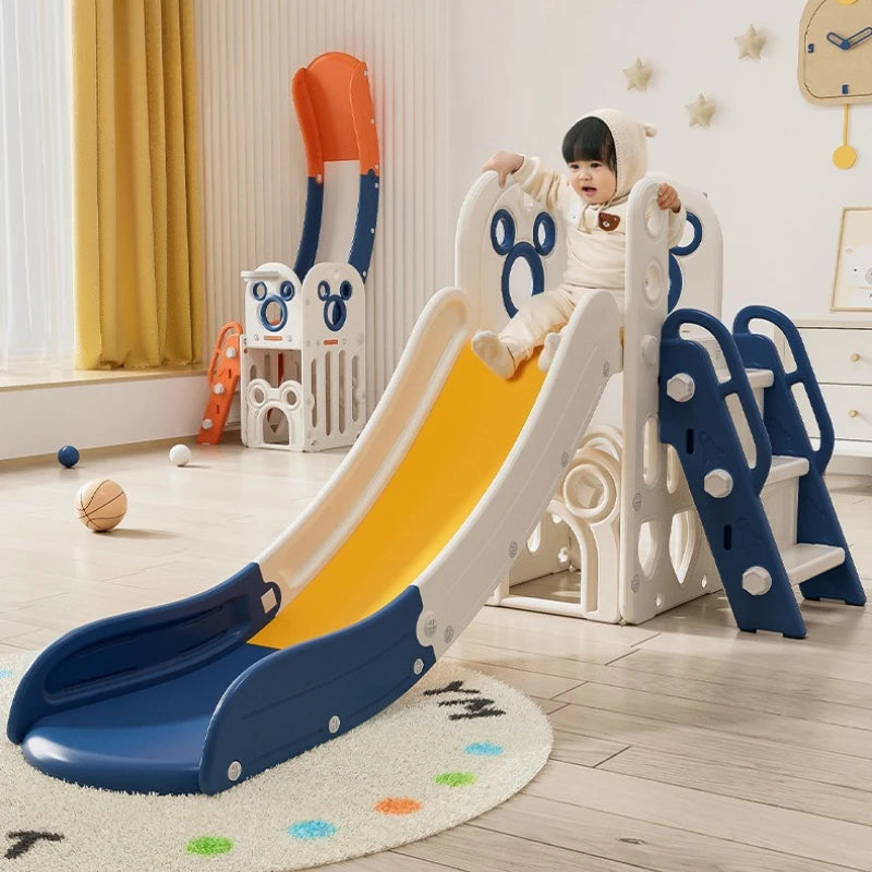 Child playing on a colorful slide in a room with toys and furniture.