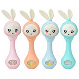 Four colorful baby rattles with bunny designs on a white background