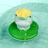 Frog-shaped toy with a yellow shell on a green lily pad in water