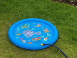 Blue inflatable water mat with cartoon fish design on grass