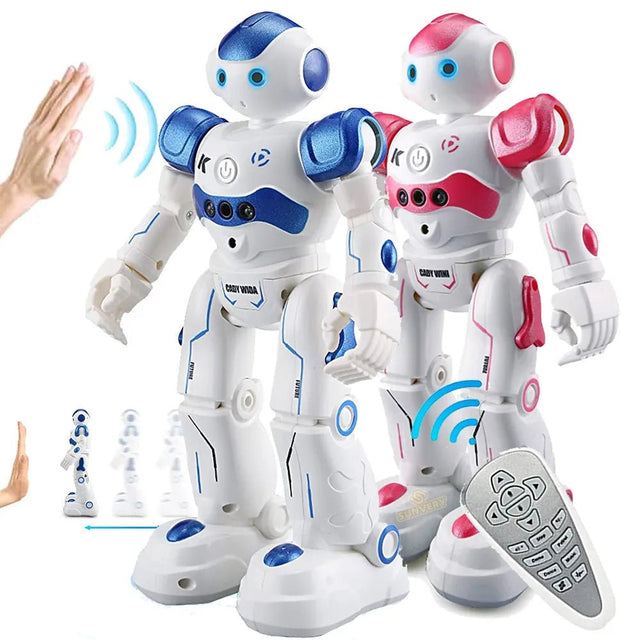 Two toy robots, one blue and white, one pink and white, with a hand reaching out to interact.