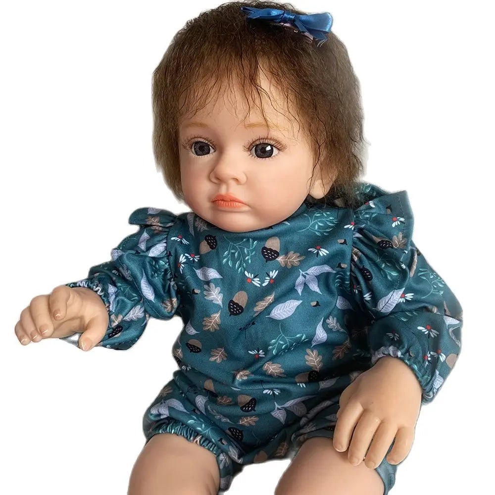 A doll wearing a teal outfit