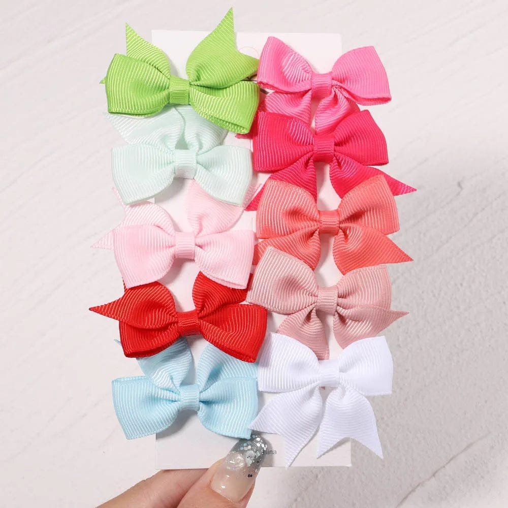 Colorful hair bows on a textured white background