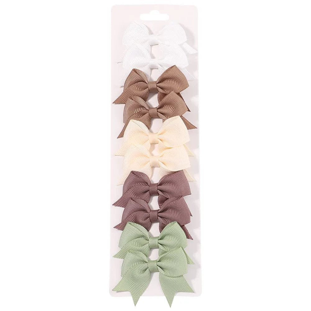 Set of five hair bows in different colors on a white background