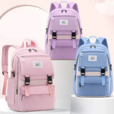 Three colorful backpacks in pink, purple, and blue.