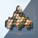 Gold airplane-shaped pop-it fidget toy with measurements on a blue and gray background