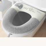 Gray toilet seat cover with 'home' branding on a toilet.
