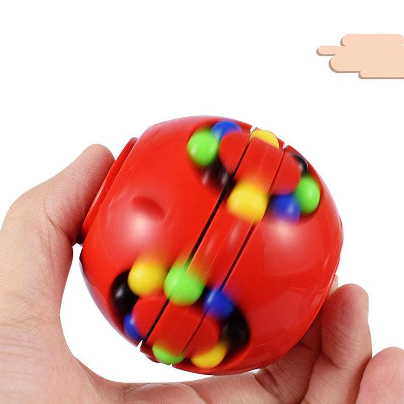 Red fidget spinner with multicolored beads held in a hand on a white background