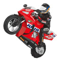Red motorcycle with a rider in a racing suit.