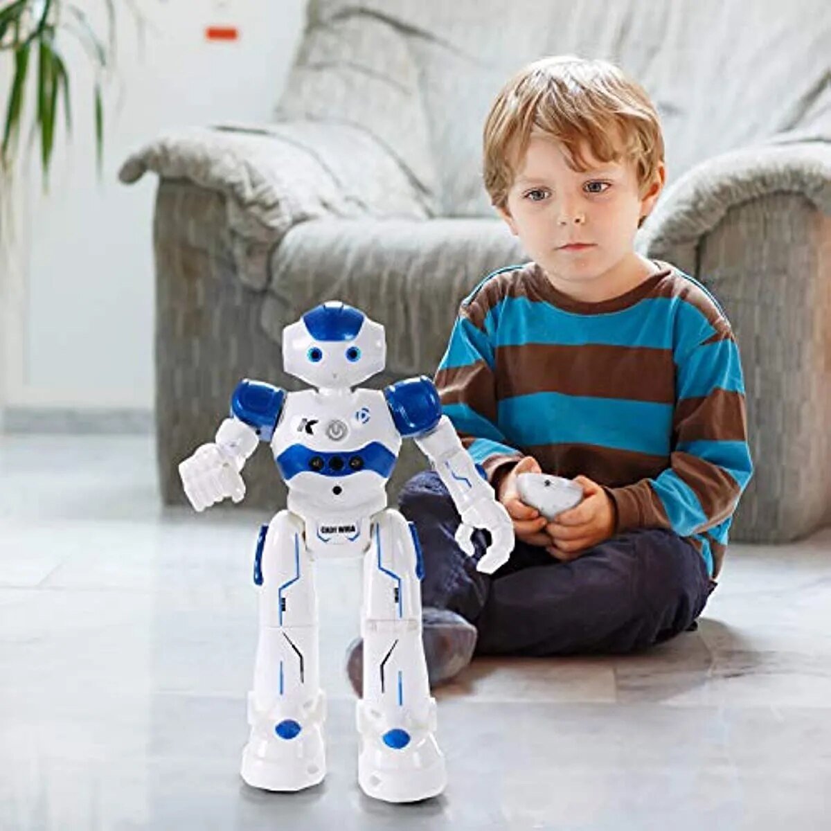 Child playing with a robot toy on a light-colored floor.