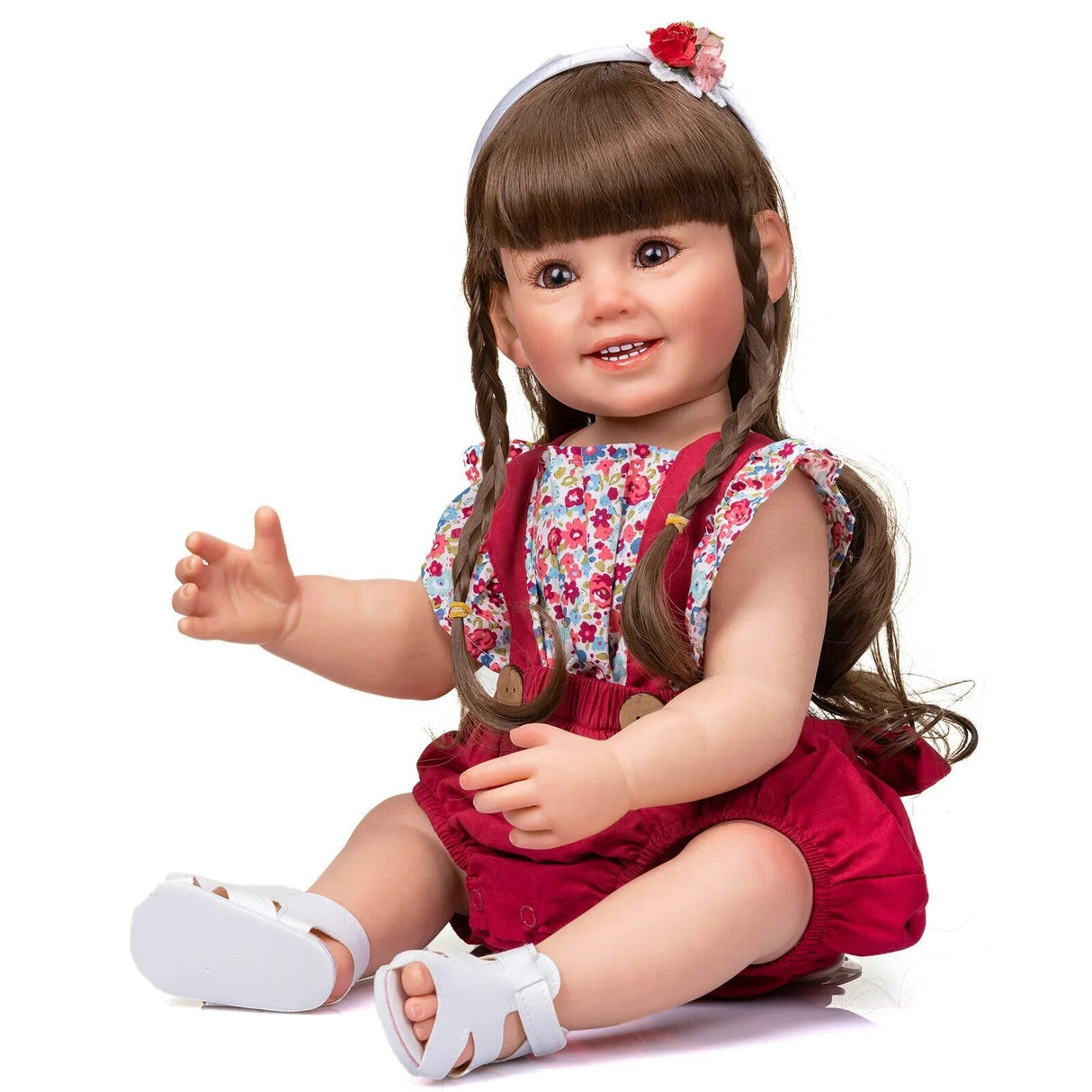 Doll with braided hair wearing a red dress and floral overalls