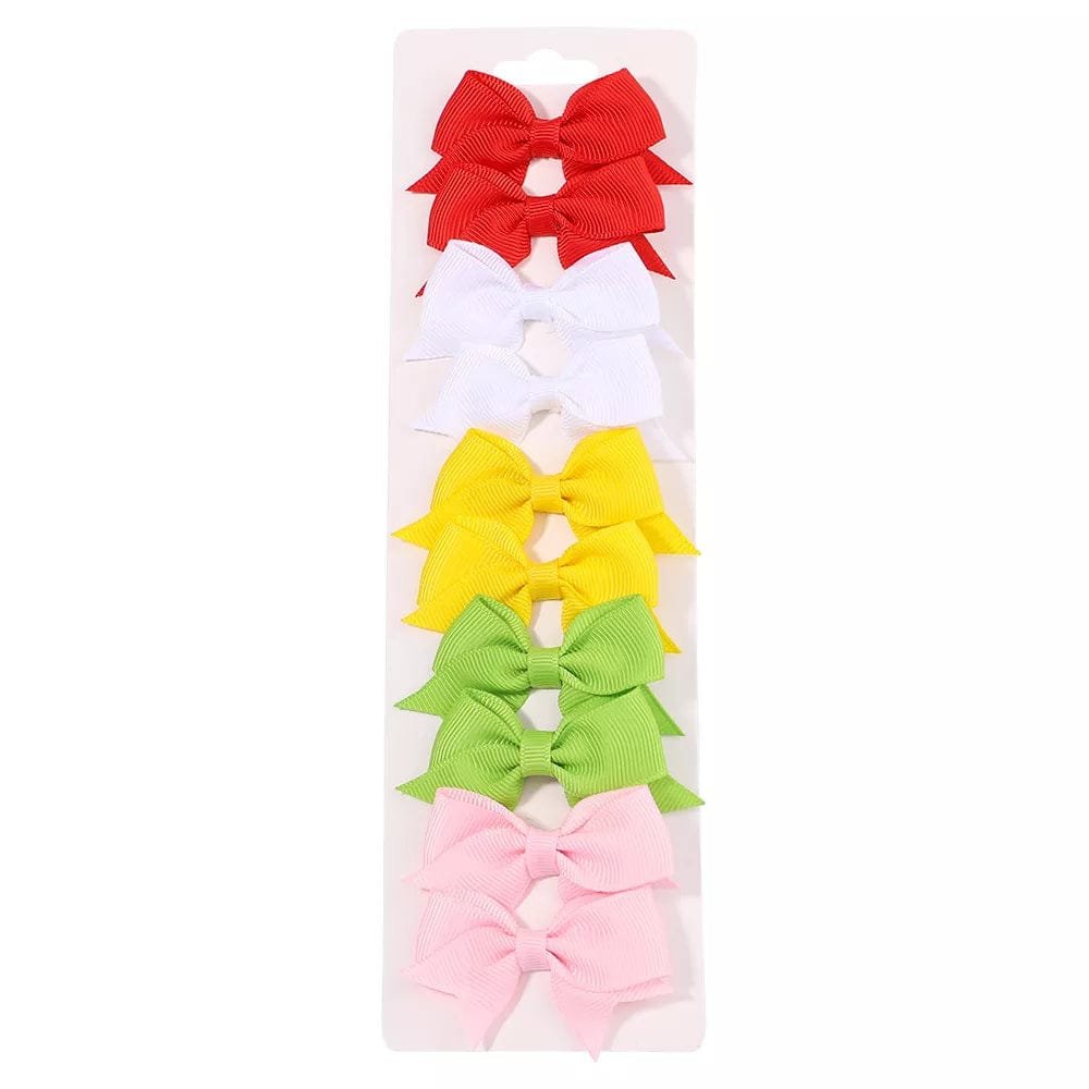 Set of colorful hair bows in a clear package on a white background