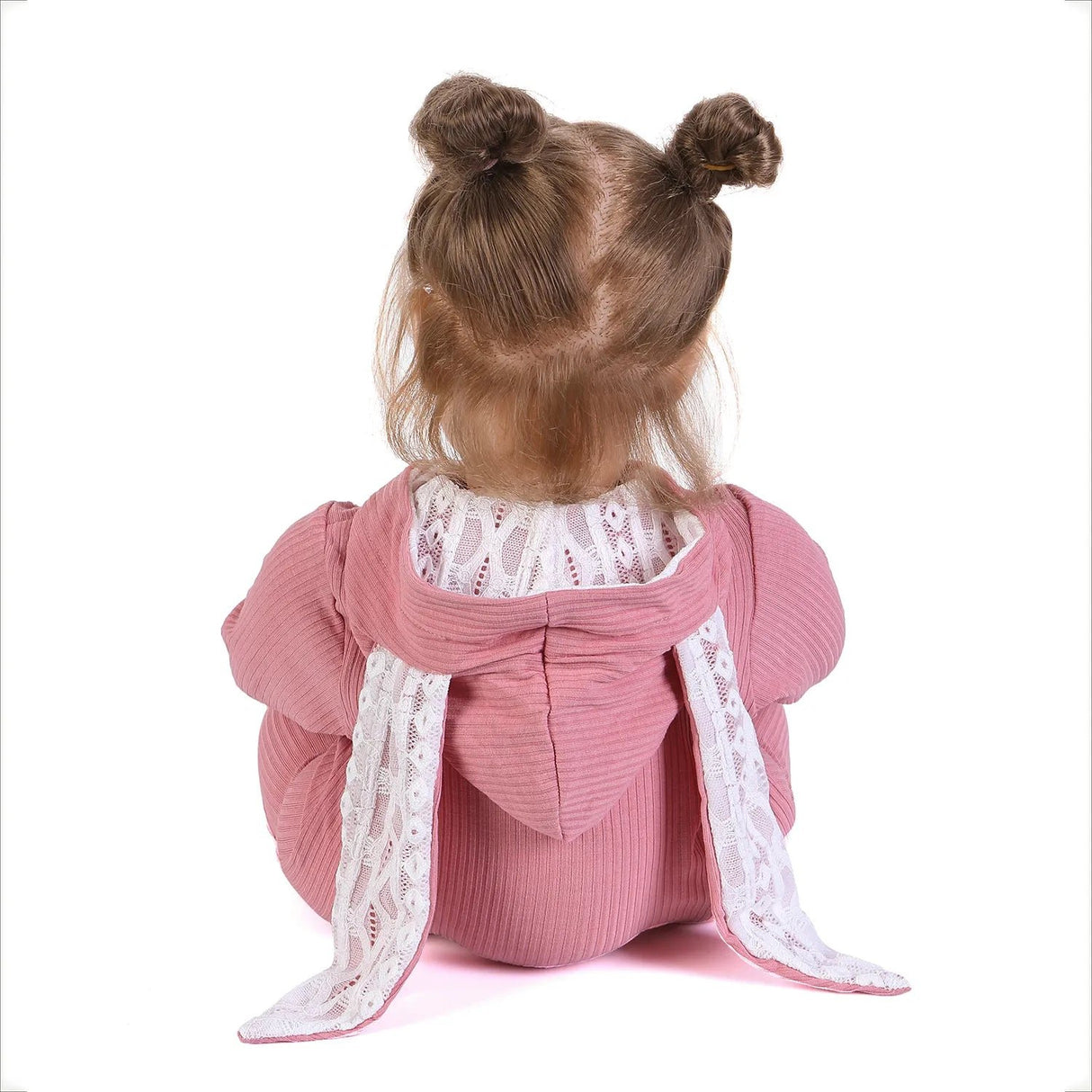 Back view of a doll wearing a pink outfit with lace details.
