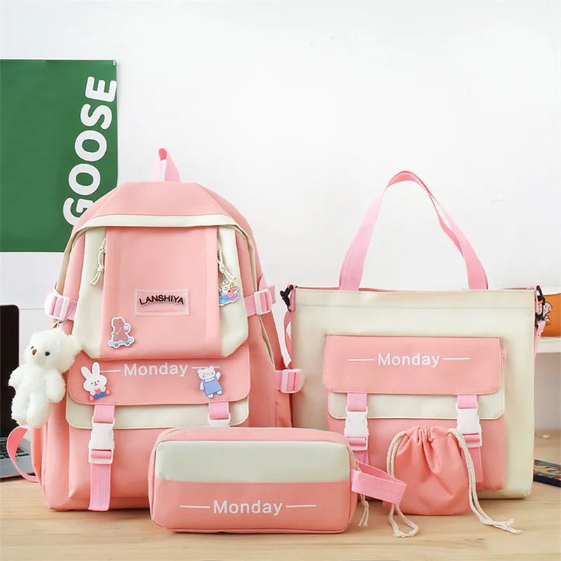 Set of pink school bags with 'Monday' labels on a wooden surface.