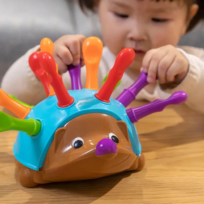 Child playing with a colorful hedgehog toy