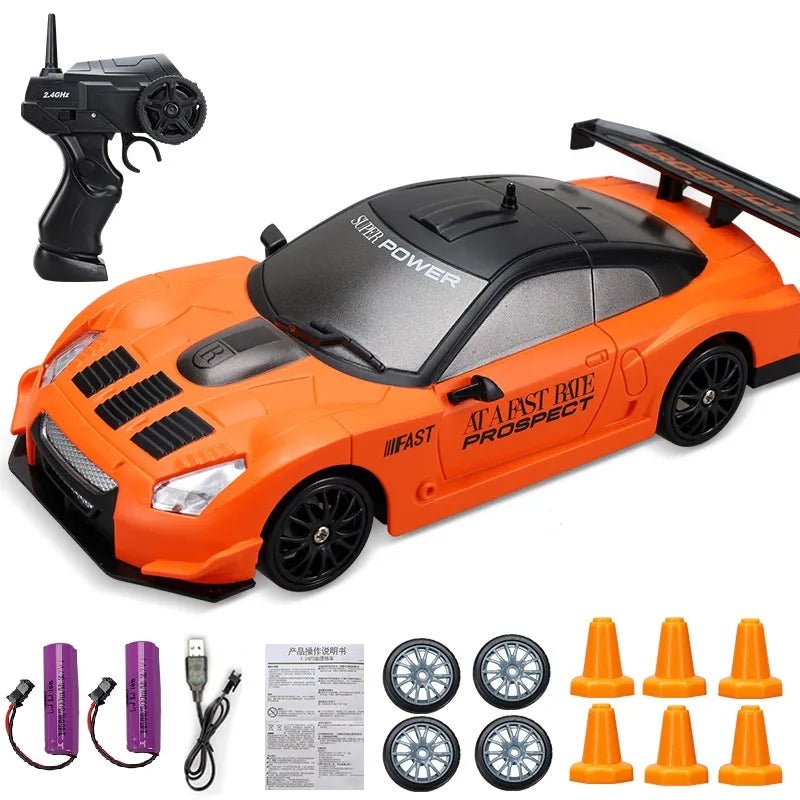 Orange toy car with remote control, batteries, and accessories