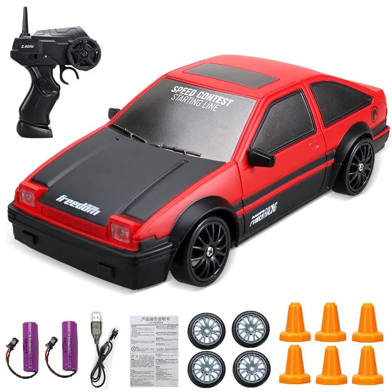 Red and black toy car with remote control, batteries, and accessories.