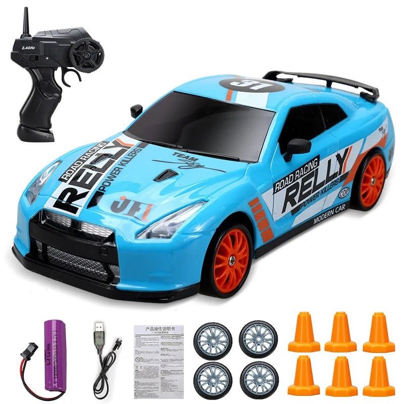 Blue toy race car with remote control, wheels, and cones.