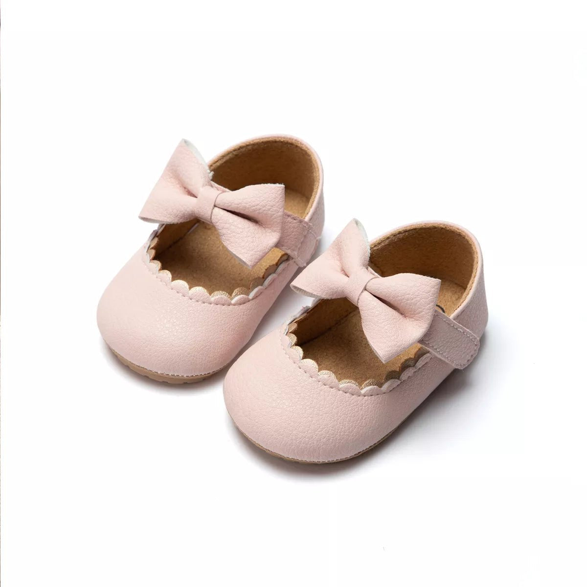 Pair of pink baby shoes with bows