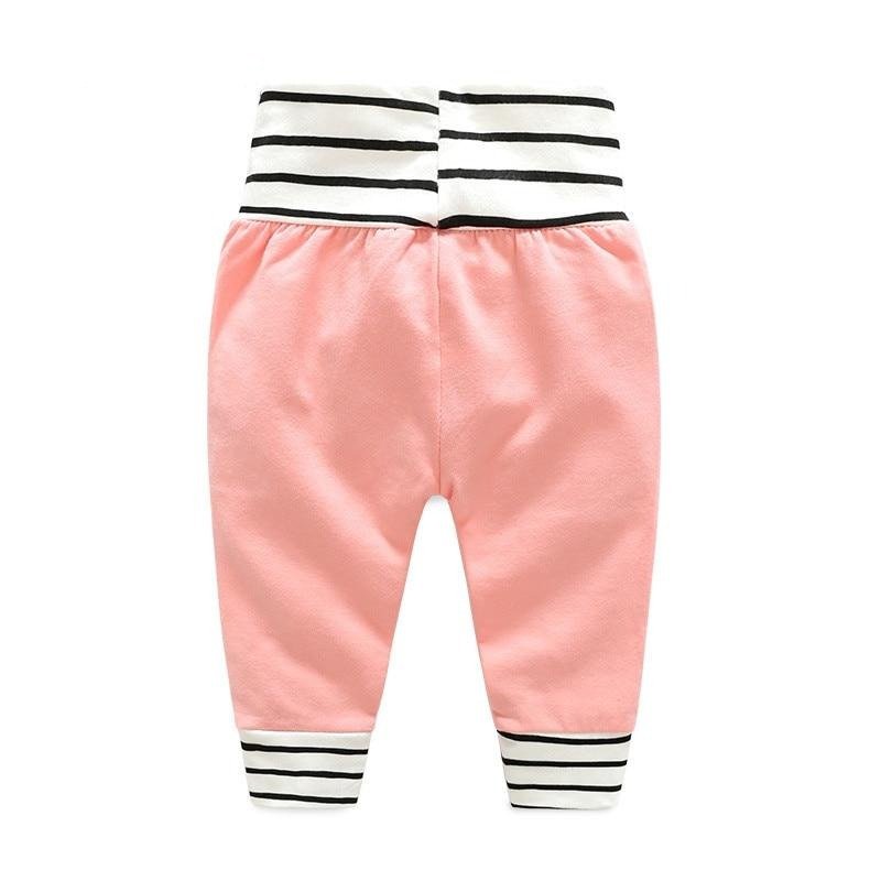 Pink pants with black and white striped details