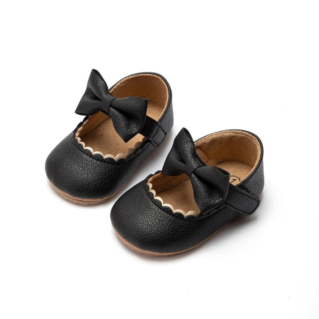 Pair of black leather shoes with bows 