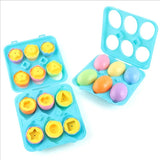 Colorful plastic ducks and eggs in blue trays.