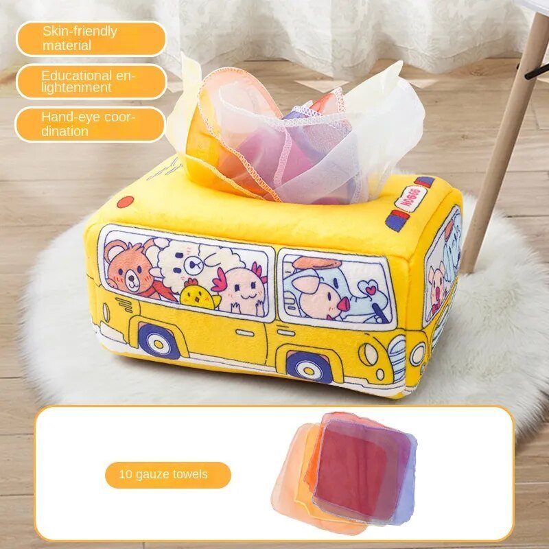 Yellow cartoon bus-shaped tissue box with tissues on a wooden floor.