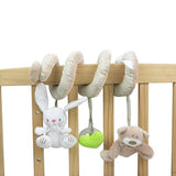 Plush toys hanging from a crib bar.