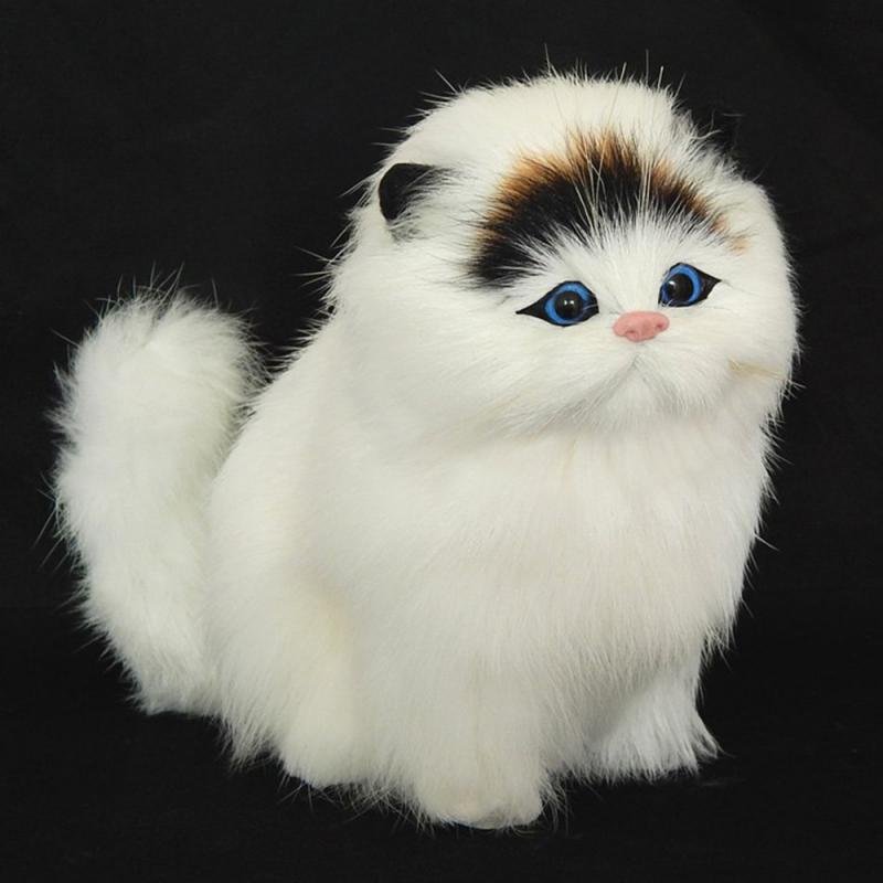 Plush toy cat with white fur and black and brown patches.