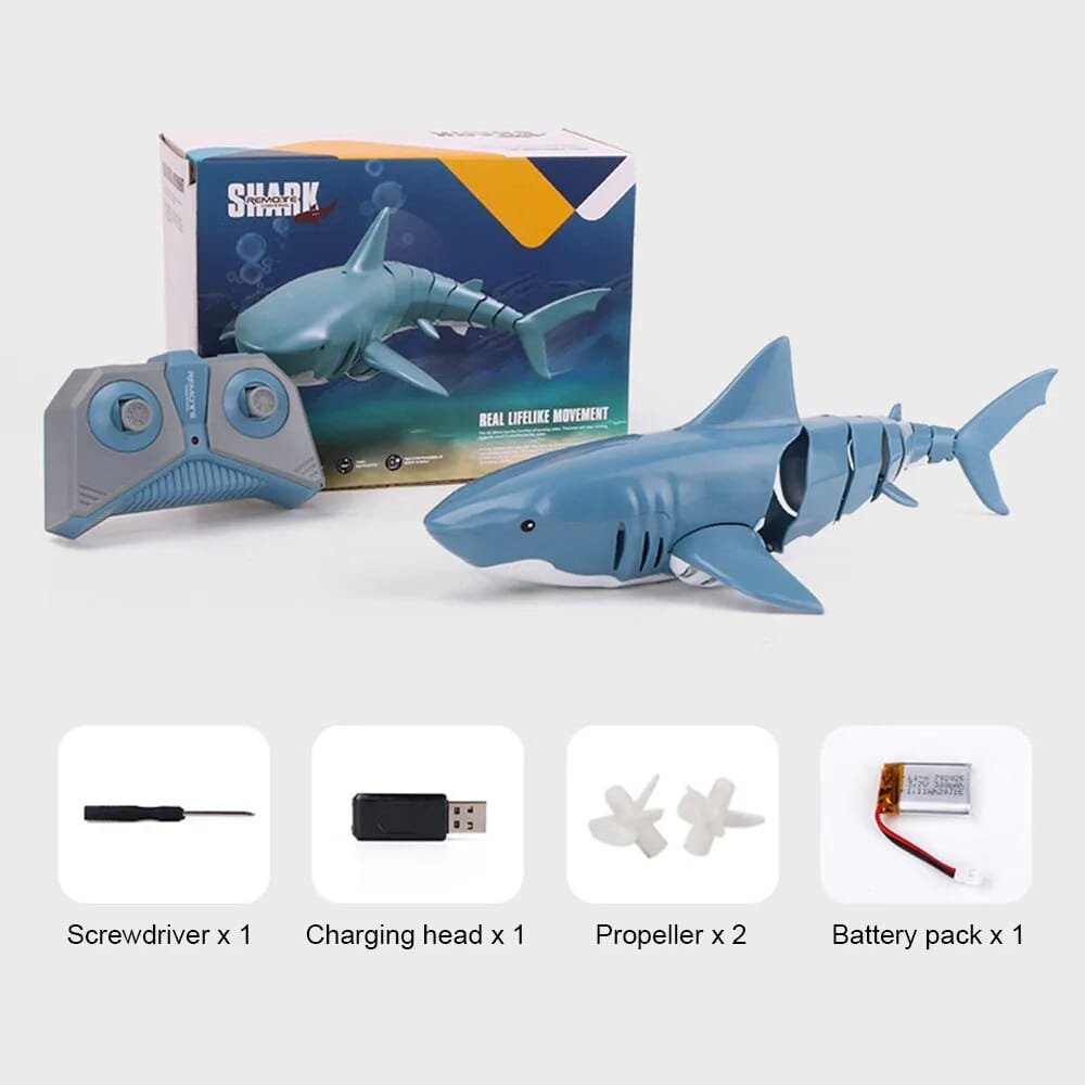 Toy shark with remote control, packaging, and accessories.
