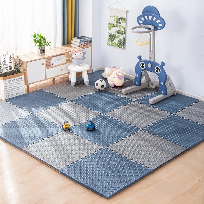 Children's playroom with blue and gray interlocking foam mats.