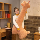Person holding a large plush llama toy in a room with wooden furniture and decor.