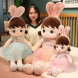 Three plush toys with bunny ears and dresses.