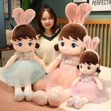 Three plush toys with bunny ears and dresses.