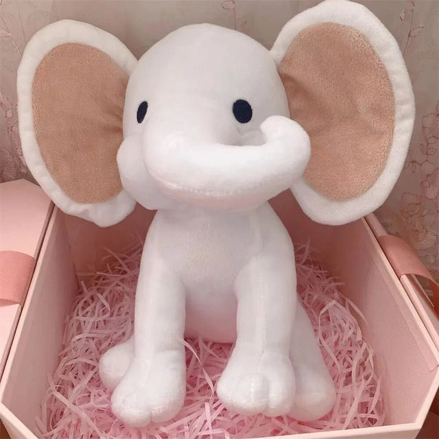 White elephant plush toy in a pink box.