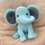 Blue elephant plush toy on a beige surface with 'Coco Plush Toy' branding.