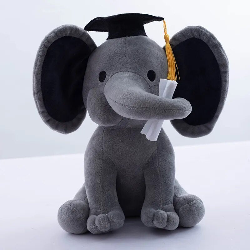 Gray plush elephant toy wearing a graduation cap and tassel.
