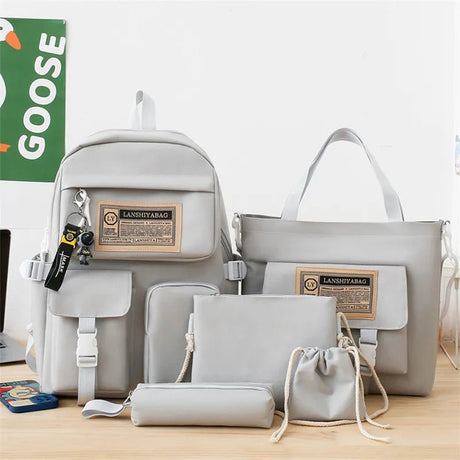 Set of gray bags including a backpack, handbag, and pouches.