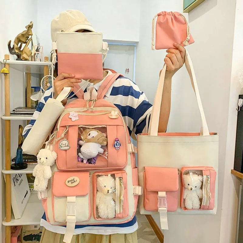 Person holding a pink backpack and tote bag with plush toys, in a room setting.