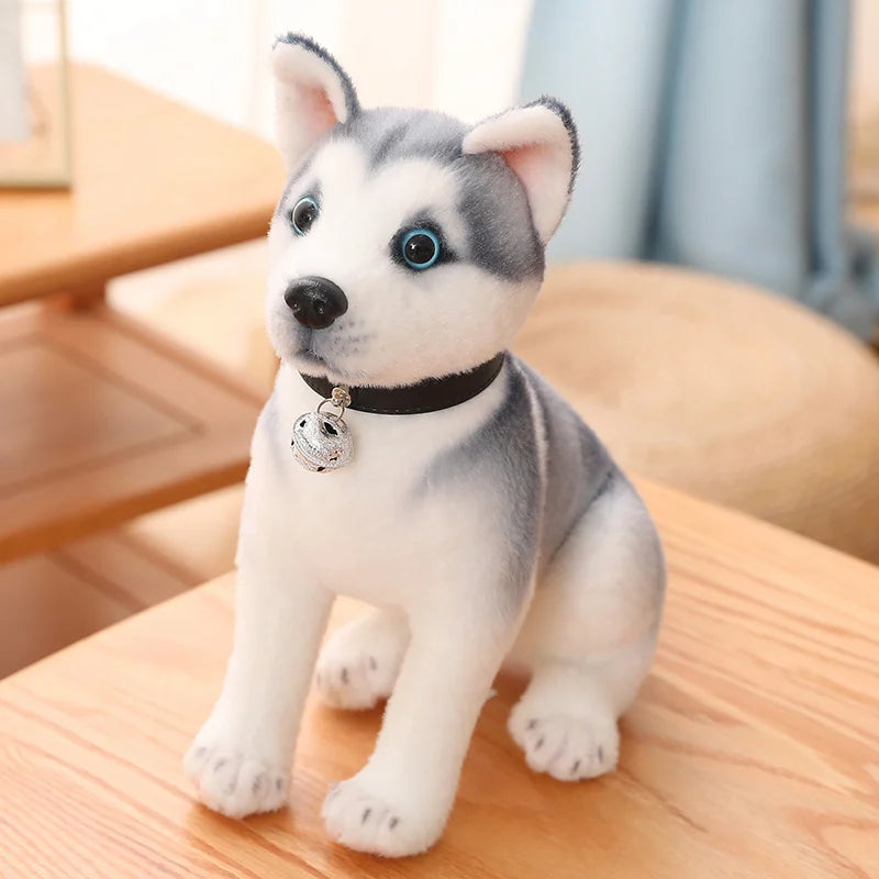 Plush toy husky dog with a bell on a wooden surface