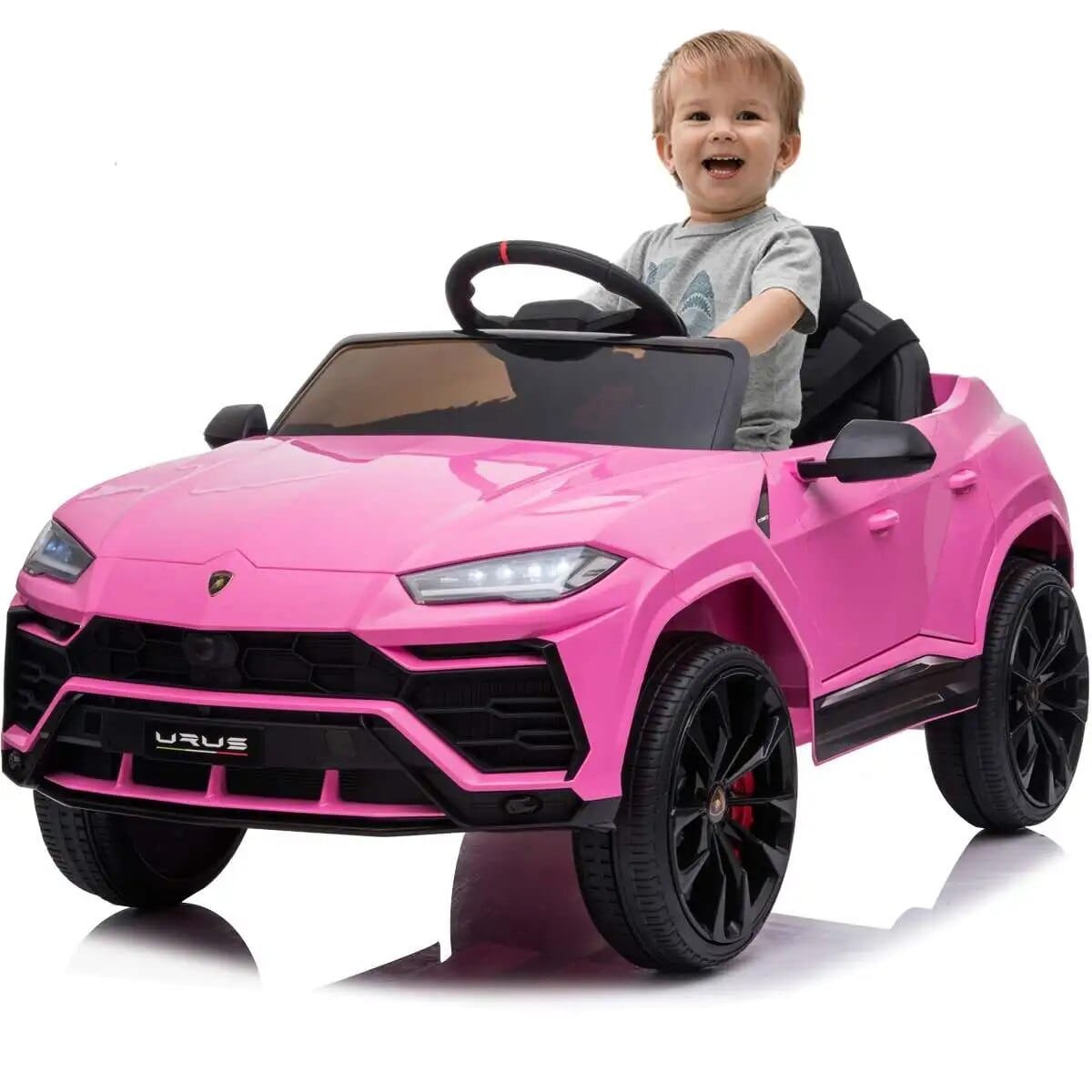 Child sitting in a pink toy Lamborghini 