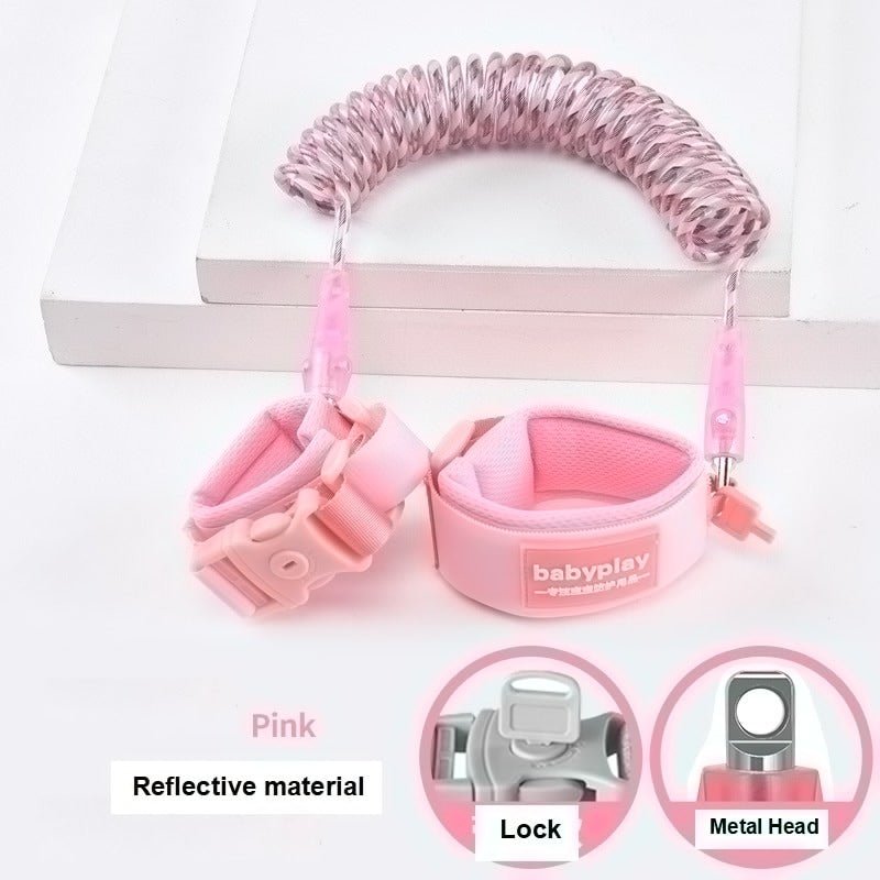 Pink child leash with wrist and ankle straps.