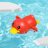 Red rubber duck floating in a pool with clear blue water.