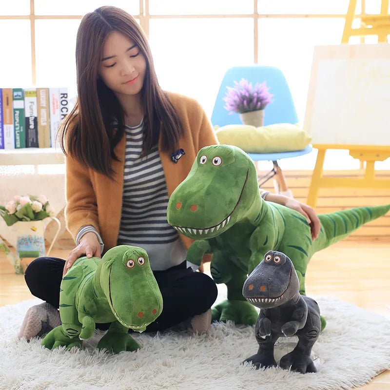 Woman holding a large green dinosaur plush toy in a room with books and decor.
