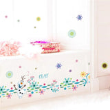Colorful wall decals with cartoon character and flowers on a white wall.