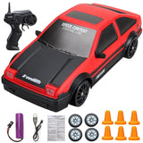 Red and black toy car with remote control, batteries, and cones.