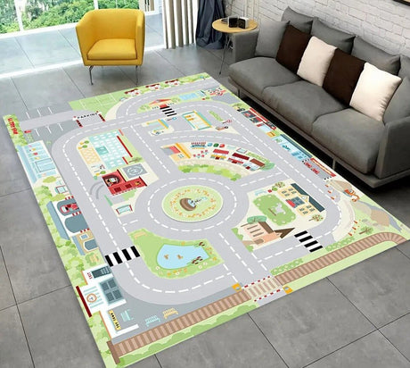 Children's play rug with road map design on a gray floor next to a gray sofa.