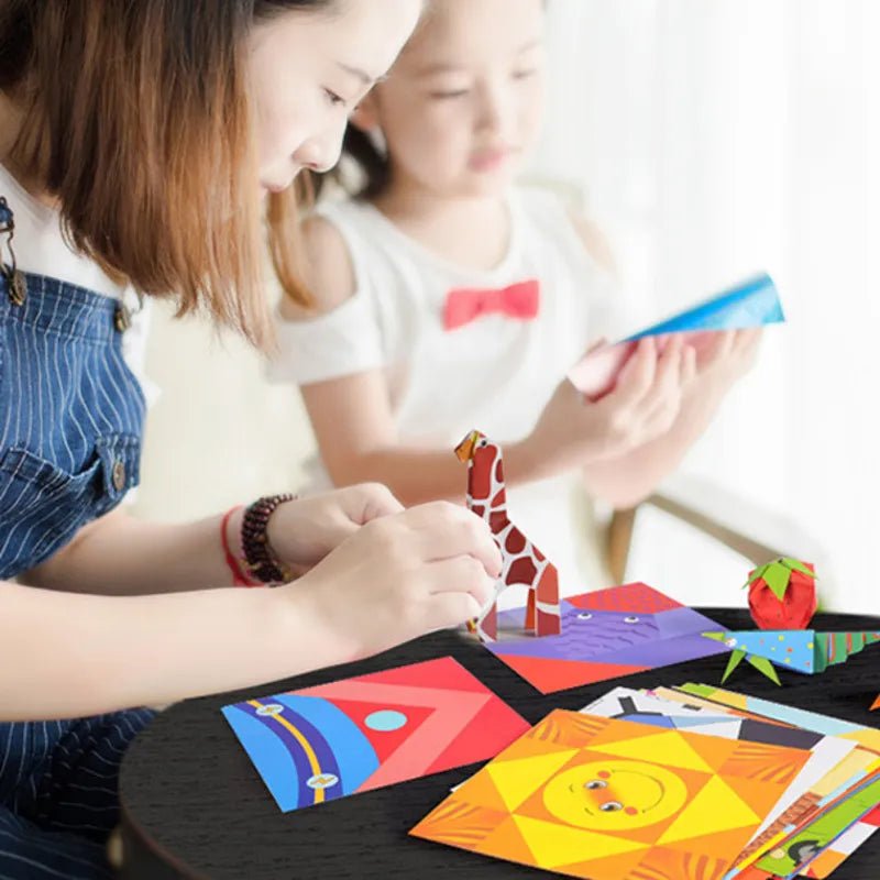 Two children playing with colorful paper crafts on a table.