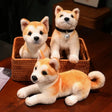 Three plush Shiba Inu dogs in a woven basket on a wooden surface.
