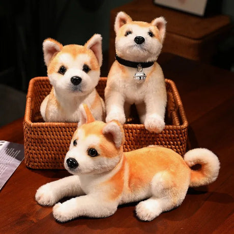 Three plush Shiba Inu dogs in a woven basket on a wooden surface.